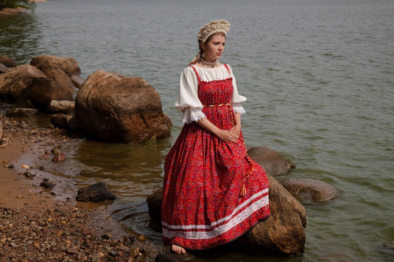 Women in Slavic costumes a quiet moment, a bright smile